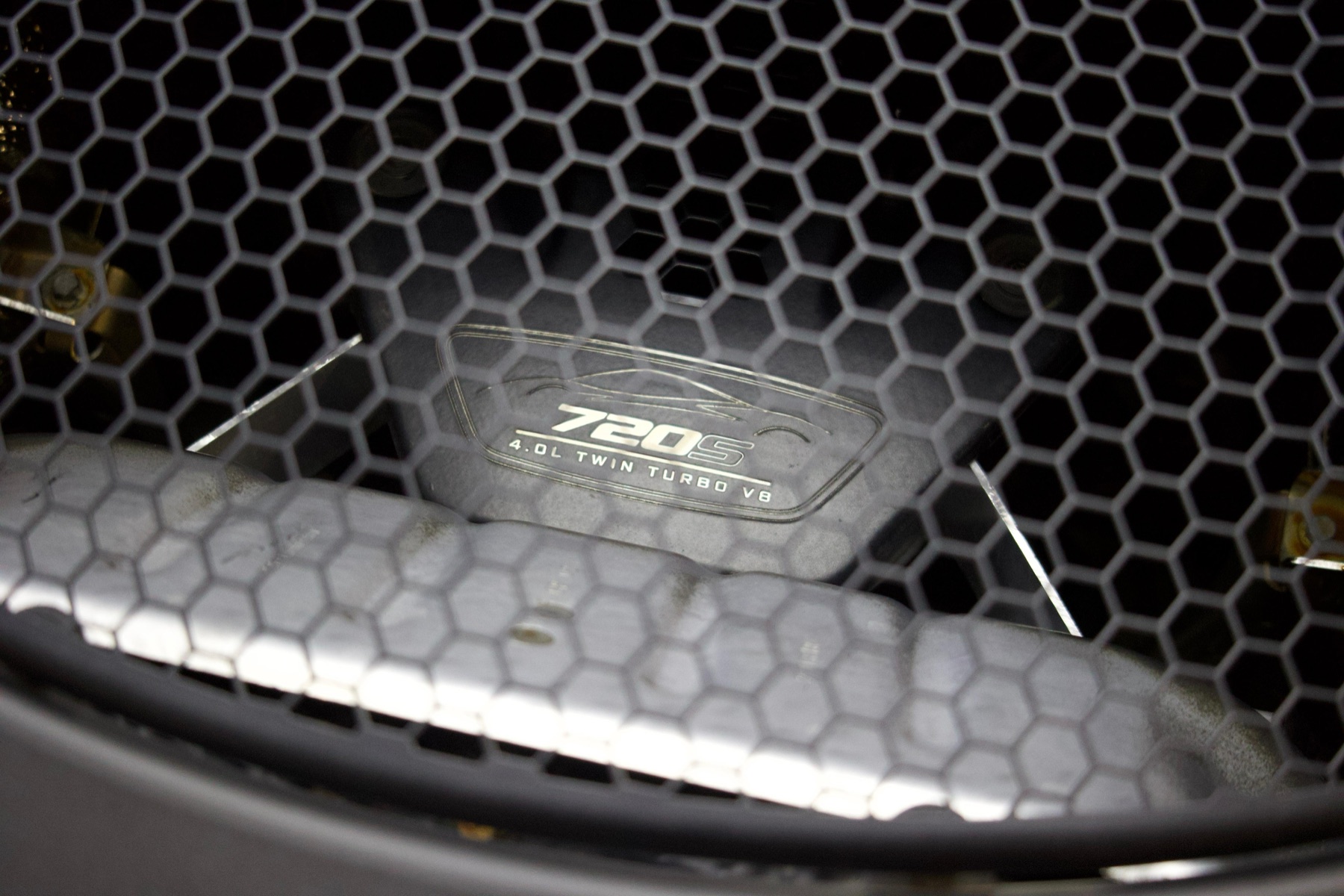 McLaren 720S engine viewed through the rear deck grille