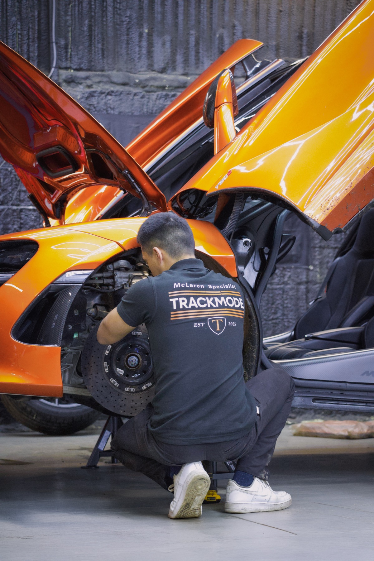 Technician working on a McLaren in the TRACKMODE workshop